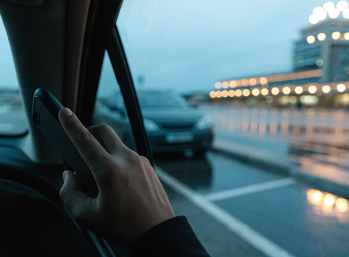 A car passing through an entry lane at a car park near Sydney Airport at blue hour